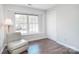 Bedroom with hardwood floors, a large window, and plenty of natural light at 8257 Legare Ct, Charlotte, NC 28210