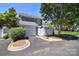 Attached garage, sidewalk and driveway, small front yard with mature landscaping at 8257 Legare Ct, Charlotte, NC 28210