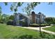 Charming two-story home with a well-manicured lawn, complemented by lush greenery and a sidewalk leading to the entrance at 8257 Legare Ct, Charlotte, NC 28210