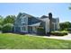 Charming two-story home with manicured lawn, lush greenery, and a welcoming entrance, framed by an American flag at 8257 Legare Ct, Charlotte, NC 28210