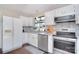 Updated kitchen featuring white cabinets, stainless appliances, and a stylish backsplash at 8257 Legare Ct, Charlotte, NC 28210