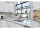 Updated kitchen sink with a garden window and view of the neighborhood at 8257 Legare Ct, Charlotte, NC 28210