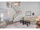 Spacious living room featuring a staircase, high ceilings, neutral furniture, and stylish decor at 8257 Legare Ct, Charlotte, NC 28210