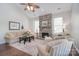 Cozy living room with a stone fireplace, high ceilings, neutral furniture, and a ceiling fan at 8257 Legare Ct, Charlotte, NC 28210