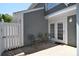 Outdoor patio with table and chairs and white fence at 8257 Legare Ct, Charlotte, NC 28210