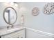 Elegant powder room with a marble countertop, stylish mirror, decorative wall art, and soft lighting at 8257 Legare Ct, Charlotte, NC 28210
