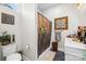 Bathroom featuring marble counters, shower-tub combo with bamboo curtain, and modern fixtures at 911 Earl St, Shelby, NC 28150
