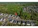 Overhead view of the property in a neighborhood setting surrounded by lush trees at 9112 Avery Meadows Dr, Charlotte, NC 28216