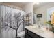 Modern bathroom vanity featuring white sink, and shower behind patterned curtain at 9112 Avery Meadows Dr, Charlotte, NC 28216