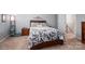 Cozy bedroom with floral bedding, a bedside table, and easy access to the home's staircase at 9112 Avery Meadows Dr, Charlotte, NC 28216