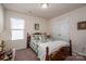 Bright bedroom with double closet, featuring window and light neutral walls at 9112 Avery Meadows Dr, Charlotte, NC 28216