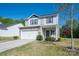 Charming two-story home with stone accents, vinyl siding, a white garage door, well-manicured front yard and wreath at 9112 Avery Meadows Dr, Charlotte, NC 28216