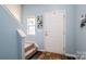 Bright foyer with wood floors, staircase and light blue walls at 9112 Avery Meadows Dr, Charlotte, NC 28216