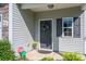 Inviting front door with dark shutters and light gray siding, adjacent to a garage at 9112 Avery Meadows Dr, Charlotte, NC 28216