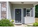 Charming front door features gray trim, gray siding, and a decorative wreath at 9112 Avery Meadows Dr, Charlotte, NC 28216