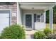 Charming home featuring a welcoming front door with a wreath and beautiful landscaping at 9112 Avery Meadows Dr, Charlotte, NC 28216