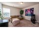 Relaxing living room with comfortable sofa, TV, and bright natural light from the window at 9112 Avery Meadows Dr, Charlotte, NC 28216