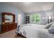 Comfortable main bedroom featuring a window with natural light and a classic dresser at 9112 Avery Meadows Dr, Charlotte, NC 28216