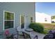 Relaxing patio featuring seating, table, and easy access to the home's interior at 9112 Avery Meadows Dr, Charlotte, NC 28216