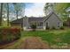 The back of the house with a patio area and freshly landscaped green lawn at 9208 Plashet Ln, Mint Hill, NC 28227