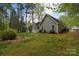 A view of the back exterior of the house featuring a well maintained lawn and partial fence at 9208 Plashet Ln, Mint Hill, NC 28227