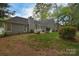 View of backyard featuring lush green grass, well-maintained landscaping, and white picket fence at 9208 Plashet Ln, Mint Hill, NC 28227