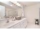 Bright bathroom with double sink vanity, large mirror, white cabinetry, and glass-enclosed shower at 9208 Plashet Ln, Mint Hill, NC 28227