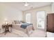 Cozy bedroom featuring a ceiling fan, bedside table, and two windows for natural light at 9208 Plashet Ln, Mint Hill, NC 28227