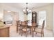 Warm dining room with a wooden table, classic chairs, natural light, and traditional accents at 9208 Plashet Ln, Mint Hill, NC 28227