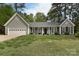 Charming single-story home with gray siding, black shutters, and a well-manicured lawn at 9208 Plashet Ln, Mint Hill, NC 28227