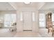 Bright foyer featuring neutral tile flooring and a glimpse into adjacent living spaces at 9208 Plashet Ln, Mint Hill, NC 28227