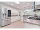 Well-lit kitchen with stainless steel appliances, granite countertops, and white cabinets and backsplash at 9208 Plashet Ln, Mint Hill, NC 28227