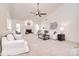 Spacious living room with vaulted ceilings, a fireplace, neutral decor, and lots of natural light at 9208 Plashet Ln, Mint Hill, NC 28227