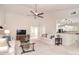 Bright living room with vaulted ceilings, ceiling fan, neutral color palette, and seamless access to the kitchen at 9208 Plashet Ln, Mint Hill, NC 28227