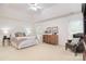 Bright main bedroom with ceiling fan, comfortable seating, dresser, and a serene atmosphere at 9208 Plashet Ln, Mint Hill, NC 28227