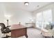 Bright home office with a classic wooden desk, chair, natural light, and neutral carpet at 9208 Plashet Ln, Mint Hill, NC 28227