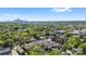 Overhead view of townhomes in wooded area with Charlotte skyline visible in distance at 921 E 36Th St, Charlotte, NC 28205