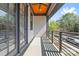 Outdoor balcony with wood ceiling, black metal railing, and a view of the neighborhood at 921 E 36Th St, Charlotte, NC 28205