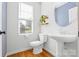 Stylish bathroom with pedestal sink, modern fixtures, and a window for natural light at 921 E 36Th St, Charlotte, NC 28205