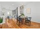 Dining area open to kitchen featuring hardwood floors, chandelier, and bright natural light at 921 E 36Th St, Charlotte, NC 28205