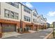 Modern townhome exterior with brick accents and a garage on a sunny day at 921 E 36Th St, Charlotte, NC 28205