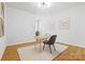 Bright office space with hardwood floors, a modern desk, chair and decorative art at 921 E 36Th St, Charlotte, NC 28205