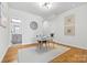 Office space with hardwood floors, a modern desk, chair and decorative art, and view to bathroom at 921 E 36Th St, Charlotte, NC 28205