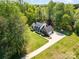 Beautiful aerial view of home with spacious yard and long driveway, surrounded by lush trees and greenery at 127 Fantasy Ln, Mooresville, NC 28117