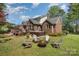 Brick home with a backyard featuring a hot tub, deck, and fire pit at 127 Fantasy Ln, Mooresville, NC 28117