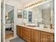 Bathroom featuring a double vanity, decorative lighting, and a bedroom view at 127 Fantasy Ln, Mooresville, NC 28117