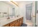Well-lit bathroom with a double sink vanity, a large mirror and a shower/tub combo at 127 Fantasy Ln, Mooresville, NC 28117