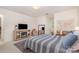 Bright bedroom featuring a cozy fireplace, TV, stylish mirror, and a comfortable striped bed at 127 Fantasy Ln, Mooresville, NC 28117