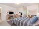 Bright bedroom featuring a cozy fireplace, TV, stylish mirror, and a comfortable striped bed at 127 Fantasy Ln, Mooresville, NC 28117
