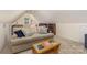 Comfortable bonus room with a cozy couch, coffee table, and bookshelf at 127 Fantasy Ln, Mooresville, NC 28117